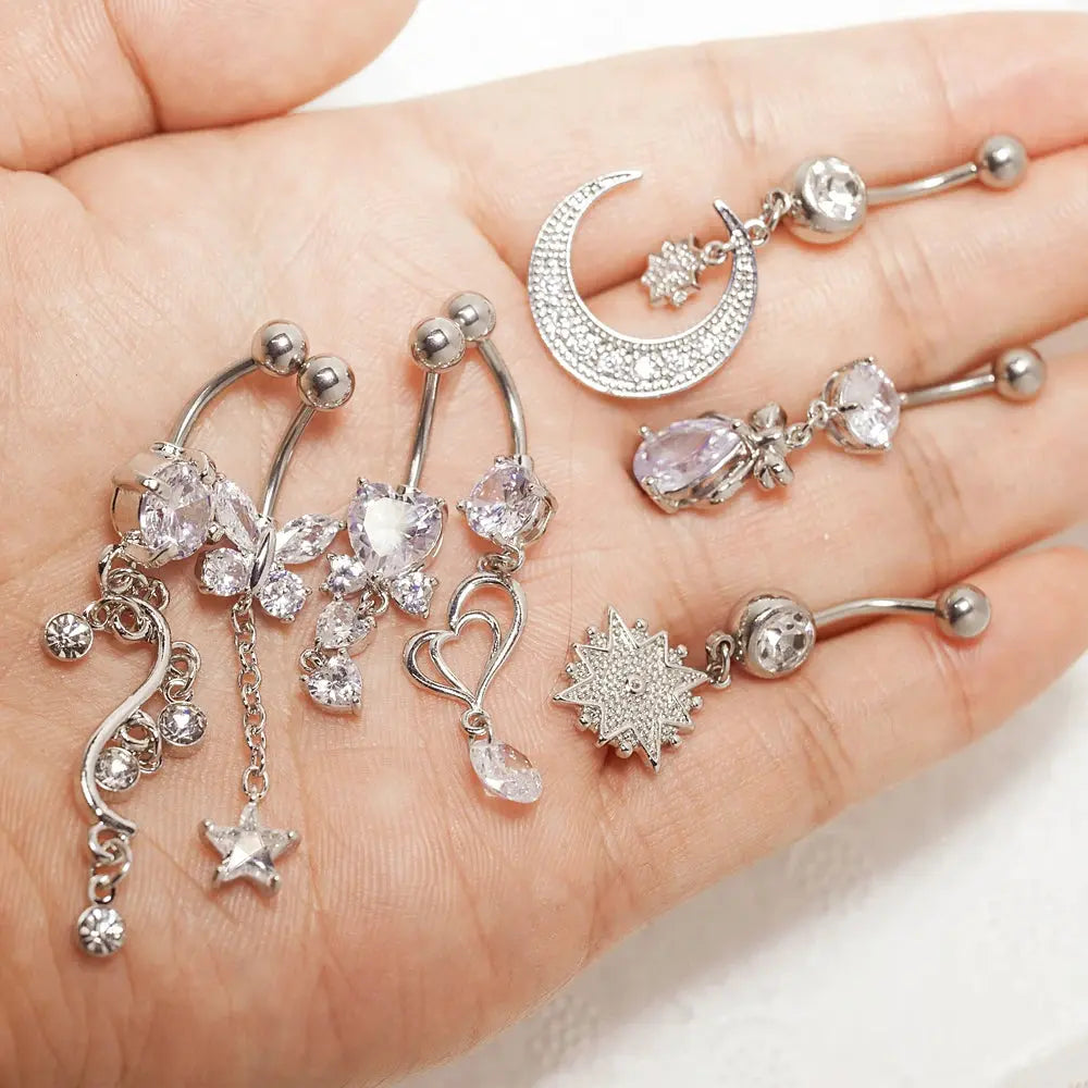 Belly Button Ring close-up in hand - opal, moon and heart designs | Veloria