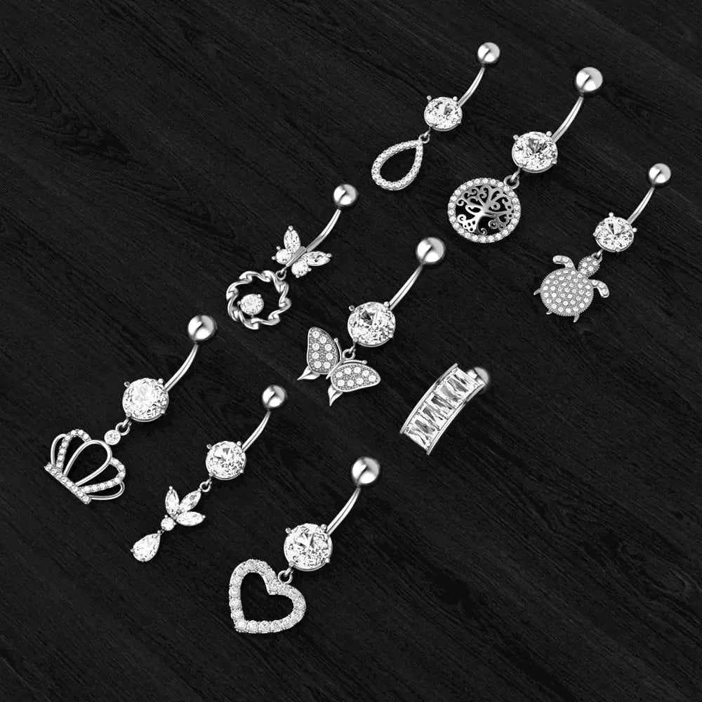 Dangle Belly Button Rings flat lay - crystal heart, crown and butterfly designs | Veloria
