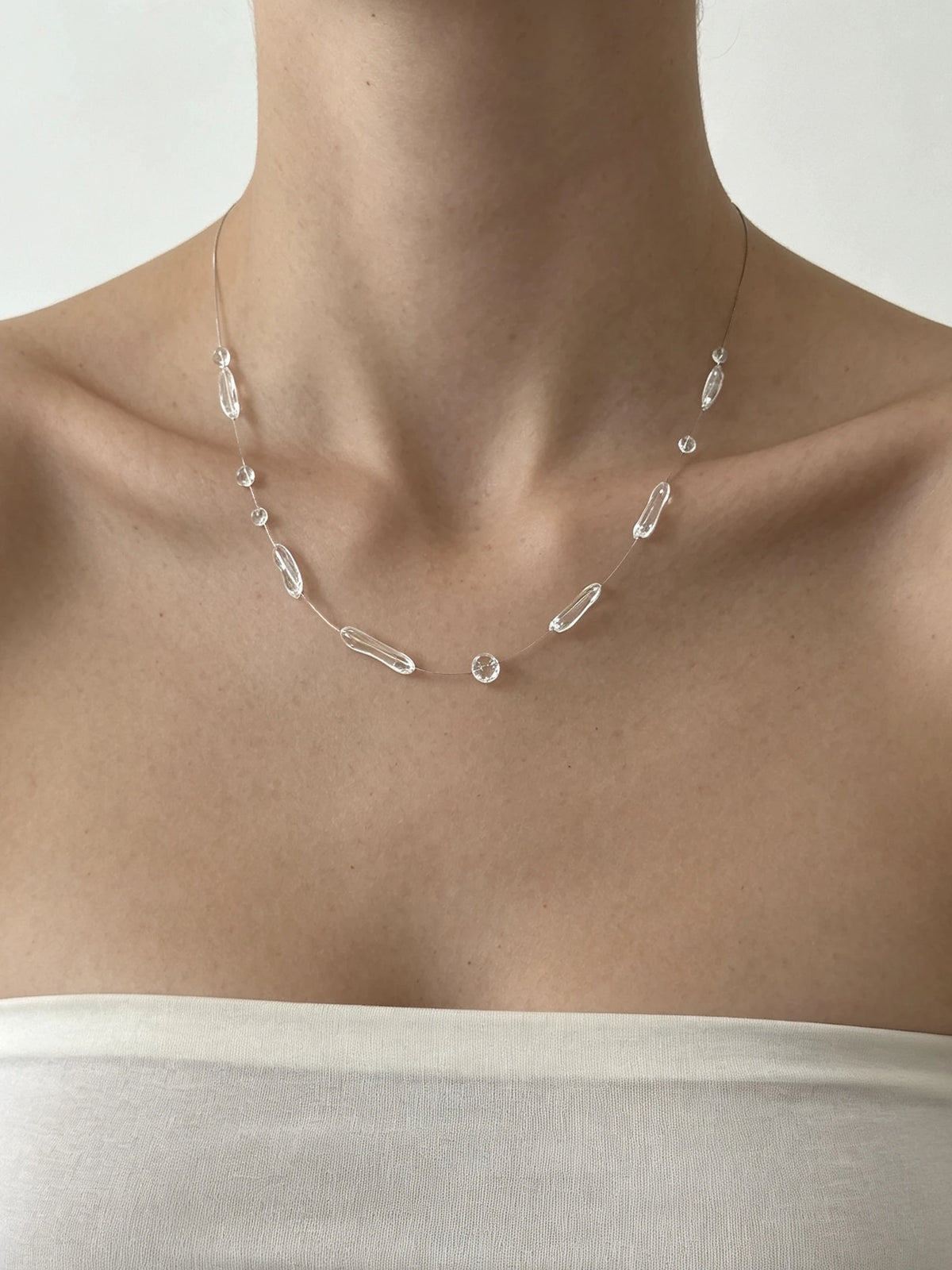 Irregular Clear Bead Necklace - Resin Dewdrop worn by model | Veloria
