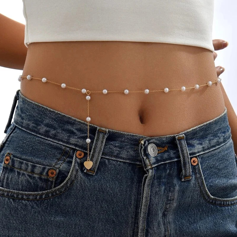 Vintage pearl belly body chain waist belt for women - worn by a woman, front view | Veloria