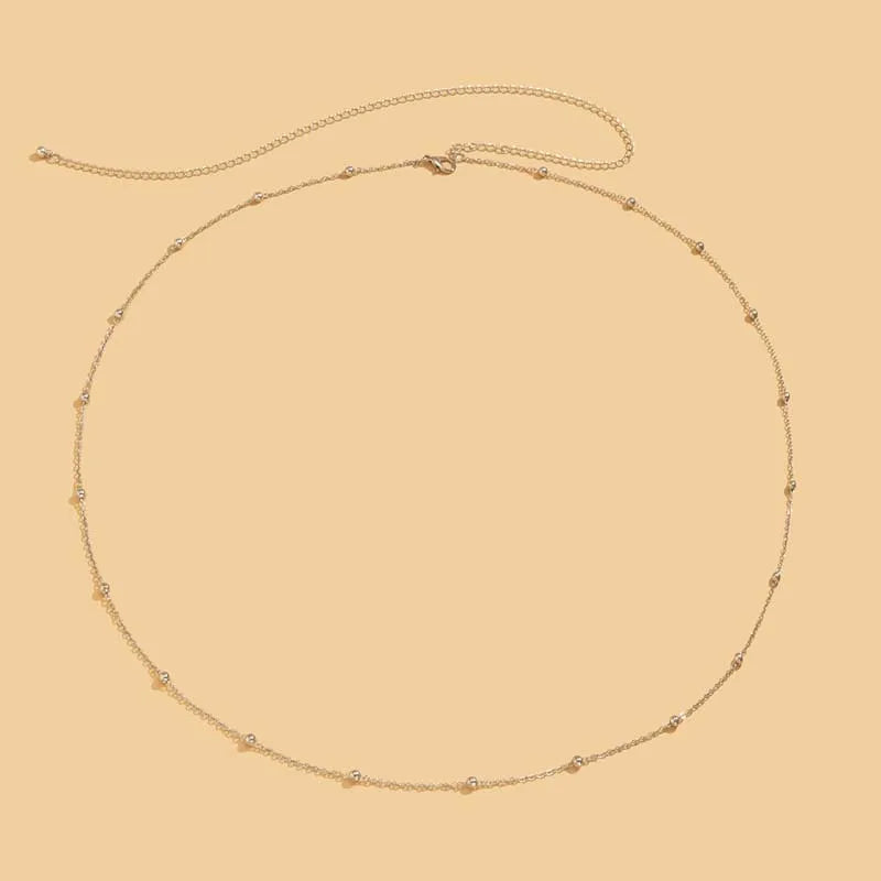 Double layer gold beaded waist chain for women - on model at an event | Veloria
