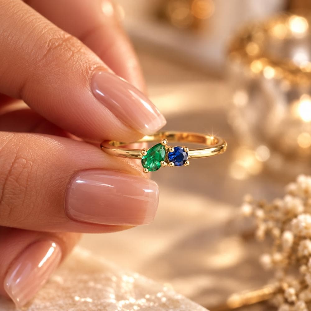Personalized birthstone ring with two heart stones worn on the hand